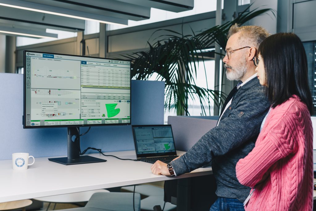 Image of two people looking at a computer | Ship Stability Management Training