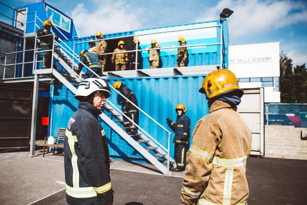 About the Maritime Skills Academy fire ground with delegates climbing the stairs of the containers