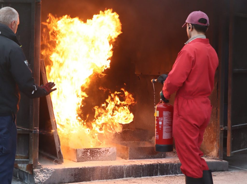 Fire Marshal delegate extinguishing a fire