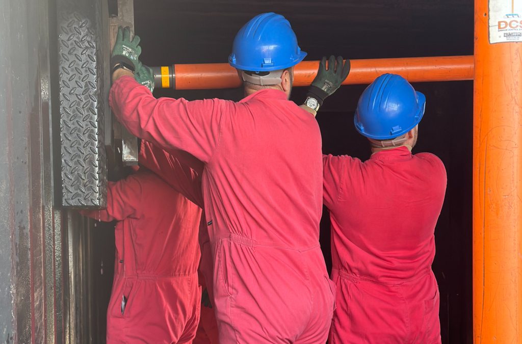 Damage control delegates holding up paratech in simulation container