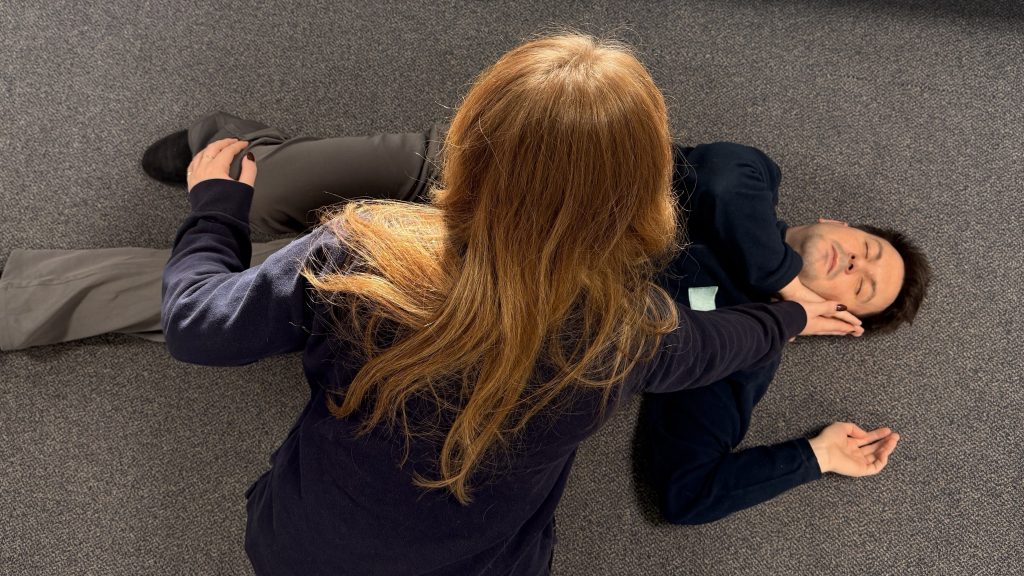 delegate demonstrating how to implicate the recovery position in the event of a workplace emergency