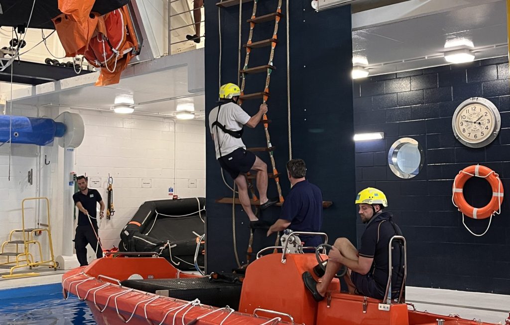 Marine pilot climbing ladder during practical marine pilot ladder transfer training
