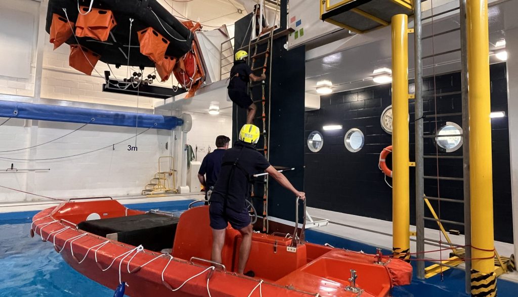 Marine pilot climbing ladder during practical marine pilot ladder transfer training