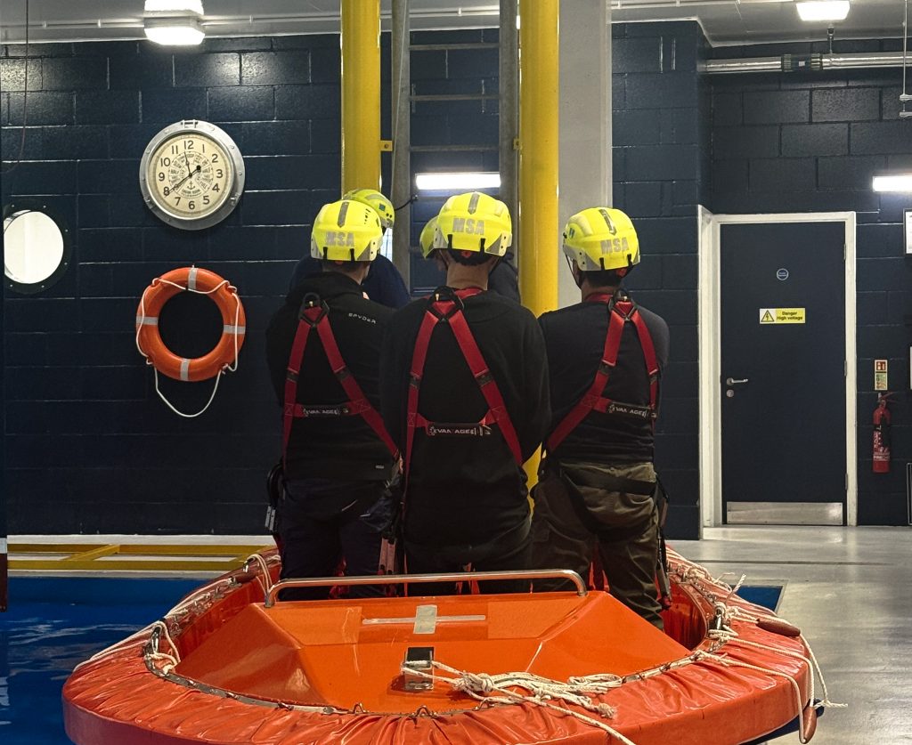 GWO delegates stood in orange speedboat with hard hats on
